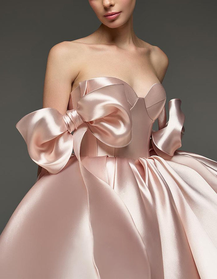 Light pink satin cocktail dress for women with sweetheart neckline and corset design featuring bow detail by FJØRNA.