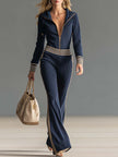 Dark blue knitted hooded zip-up V-neck jumpsuit by FJØRNA, featuring a cozy knit fabric and casual stylish design.