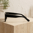 FJØRNA unisex vintage rectangular sunglasses with dark tinted lenses and black frames, accessory for women and men.