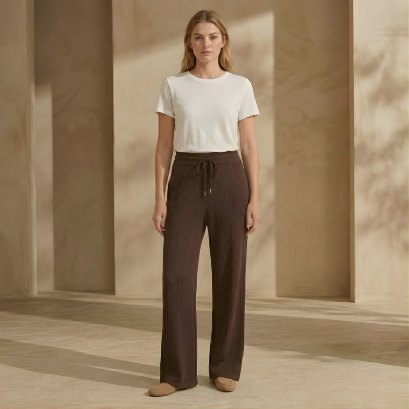 FJØRNA women's knit lounge trousers with cable-knit pattern, featuring a relaxed fit and cozy knit fabric.