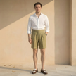 Men's high waist linen shorts by FJØRNA with pleats, lightweight and stylish for casual summer wear.