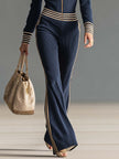 Dark blue knitted hooded zip-up V-neck jumpsuit by FJØRNA, featuring a cozy, stylish design with a front zipper and hood.
