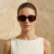 FJØRNA retro rectangular unisex sunglasses with black frames and dark lenses, stylish accessories for women and men.