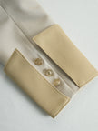 FJØRNA khaki belted waist two-piece trouser set with tailored pants and matching top, styled for a chic, casual look.