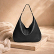 Large FJØRNA leather bag for women, stylish and spacious with a smooth leather finish and sturdy shoulder strap.