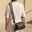 FJØRNA genuine leather chevron strap crossbody bag for women with a sleek design and adjustable strap.