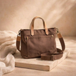 Large canvas messenger bag for women by FJØRNA, featuring a stylish and spacious design with adjustable strap and front pocket.