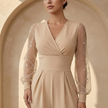 Women’s V neck mesh sleeve evening jumpsuit by FJØRNA, stylish black women’s set with elegant V neckline and mesh sleeve details.