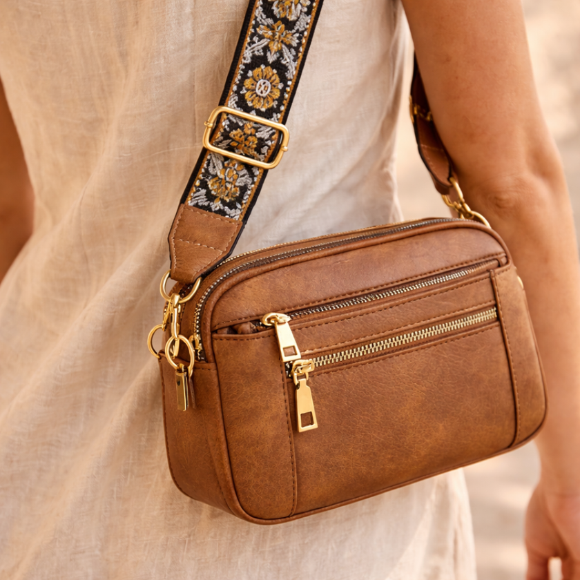 FJØRNA leather shoulder bag for women with sleek design, featuring adjustable strap and spacious interior for everyday use.