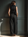 FJØRNA cotton-linen sleeveless jumpsuit for women featuring a collared neckline, cargo pockets, and wide-leg pants.