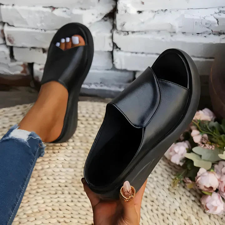 FJØRNA Eliza™ orthopedic slip-on wedge sandals with cushioned insole and supportive design, featuring tan leather straps and chunky heel.
