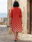 FJØRNA women's polka dot summer dress, flowy wrap style with short sleeves and a fitted waist, ideal for warm weather.