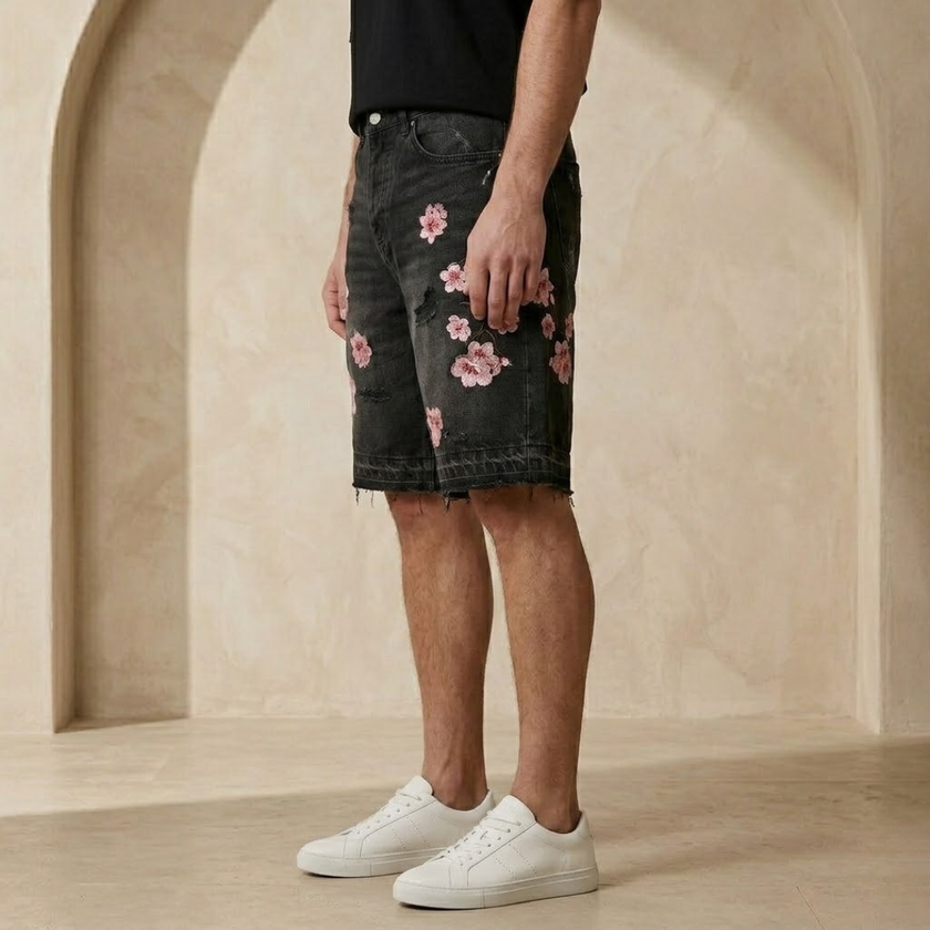Men's denim shorts by FJØRNA with floral pattern, casual summer shorts, front view showing distressed details and vibrant design.