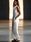White linen sleeveless wide-leg jumpsuit for women by FJØRNA, featuring a relaxed fit and elegant design.