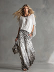 White chiffon button-up shirt for women by FJØRNA, featuring a classic collar and long sleeves, displayed on a hanger.
