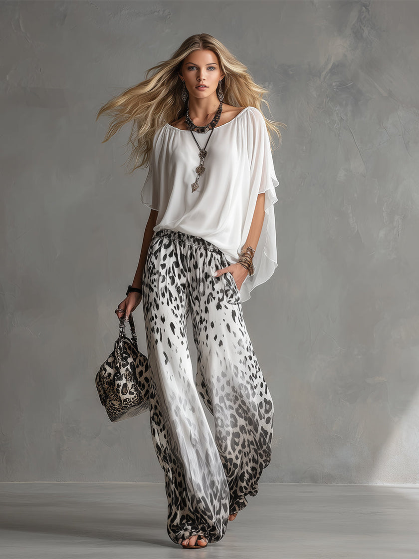 White chiffon button-up shirt for women by FJØRNA, featuring a classic collar and long sleeves, displayed on a hanger.