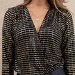FJØRNA women's glitter long sleeve top featuring a shimmering fabric and fitted design, ideal for stylish evening wear.