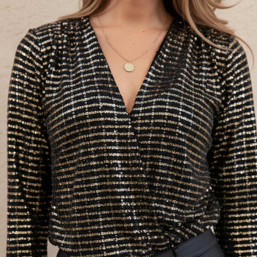 FJØRNA women's glitter long sleeve top featuring a shimmering fabric and fitted design, ideal for stylish evening wear.