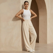 Women’s high waisted tailored wide-leg trousers by FJØRNA, showcasing the sleek fit and wide leg design on a neutral background.