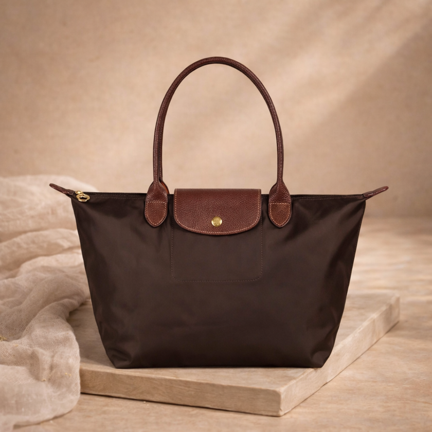 FJØRNA leather tote bag for women, large foldable bag in black with spacious interior and sturdy handles.