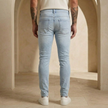 Men's tailored denim jeans by FJØRNA, showcasing classic five-pocket design and slim fit in durable blue denim.