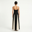 Women's contrast color maxi dress with spaghetti straps by FJØRNA, featuring a flowing silhouette and vibrant color blocks.