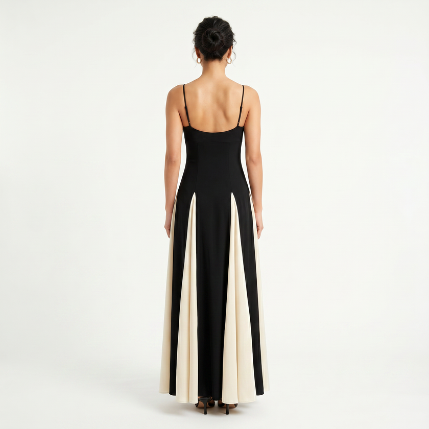 Women's contrast color maxi dress with spaghetti straps by FJØRNA, featuring a flowing silhouette and vibrant color blocks.