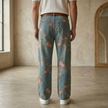 Men's denim jeans from FJØRNA featuring floral pattern, casual pants with classic fit and stylish design.