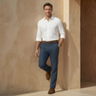 FJØRNA men's linen blend straight leg trousers showing tailored fit and neutral beige color on a clean background.