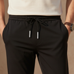 Men's FJØRNA trousers, stylish and comfortable pants featuring a modern fit and classic design, ideal for casual or semi-formal wear.