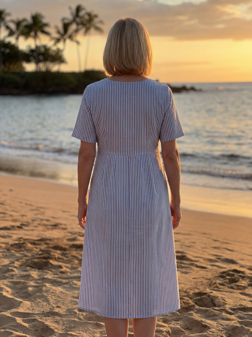 FJØRNA summer midi dress for women with striped pattern, short sleeves, and pockets, perfect for warm weather.