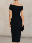 FJØRNA minimalist black asymmetric one-shoulder midi dress on a model, showcasing sleek design and elegant fit.