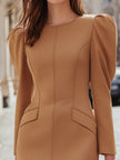 FJØRNA camel leather mini dress with puff sleeves and structured tailoring, showcasing a stylish and sleek silhouette.