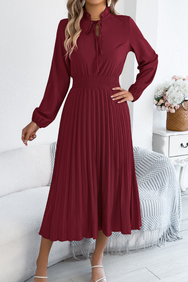 FJØRNA solid color long-sleeved fitted waist pleated elegant midi dress displayed on a hanger.