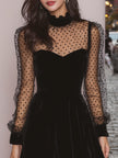 FJØRNA velvet evening dress with elegant design, featuring a flowing silhouette and rich fabric for formal occasions.