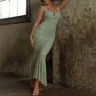 FJØRNA ruched mermaid evening dress with fitted silhouette and elegant design, displayed on a hanger.