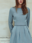 FJØRNA vintage tweed long-sleeved midi dress with a fitted waist and classic pattern, displayed on a hanger against a neutral background.