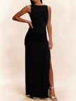 FJØRNA white sleeveless maxi dress with ruched bodice and side slit, flowing floor-length design perfect for elegant occasions.