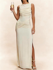 FJØRNA white sleeveless ruched maxi dress with slit, flowing fabric, and elegant design perfect for summer or special occasions.