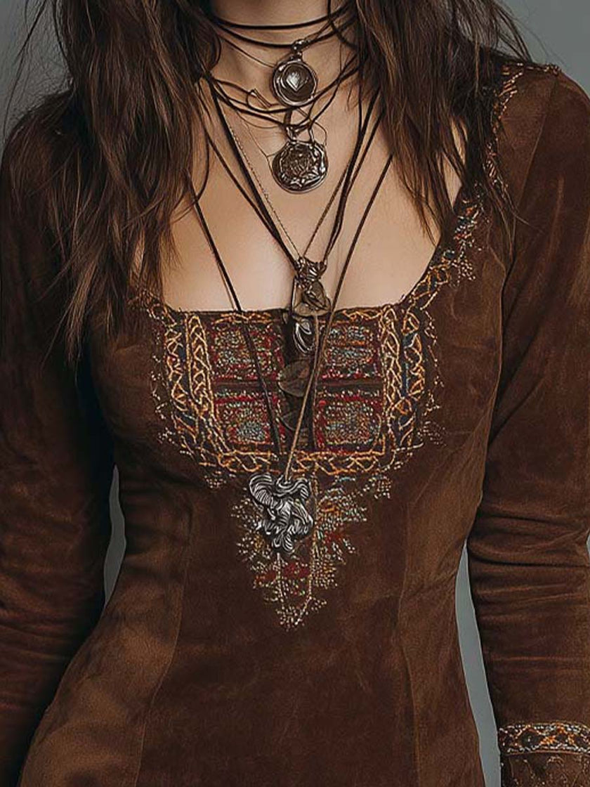 Vintage brown suede mini dress with embroidered detailing from FJØRNA, featuring a fitted silhouette and decorative embroidery.