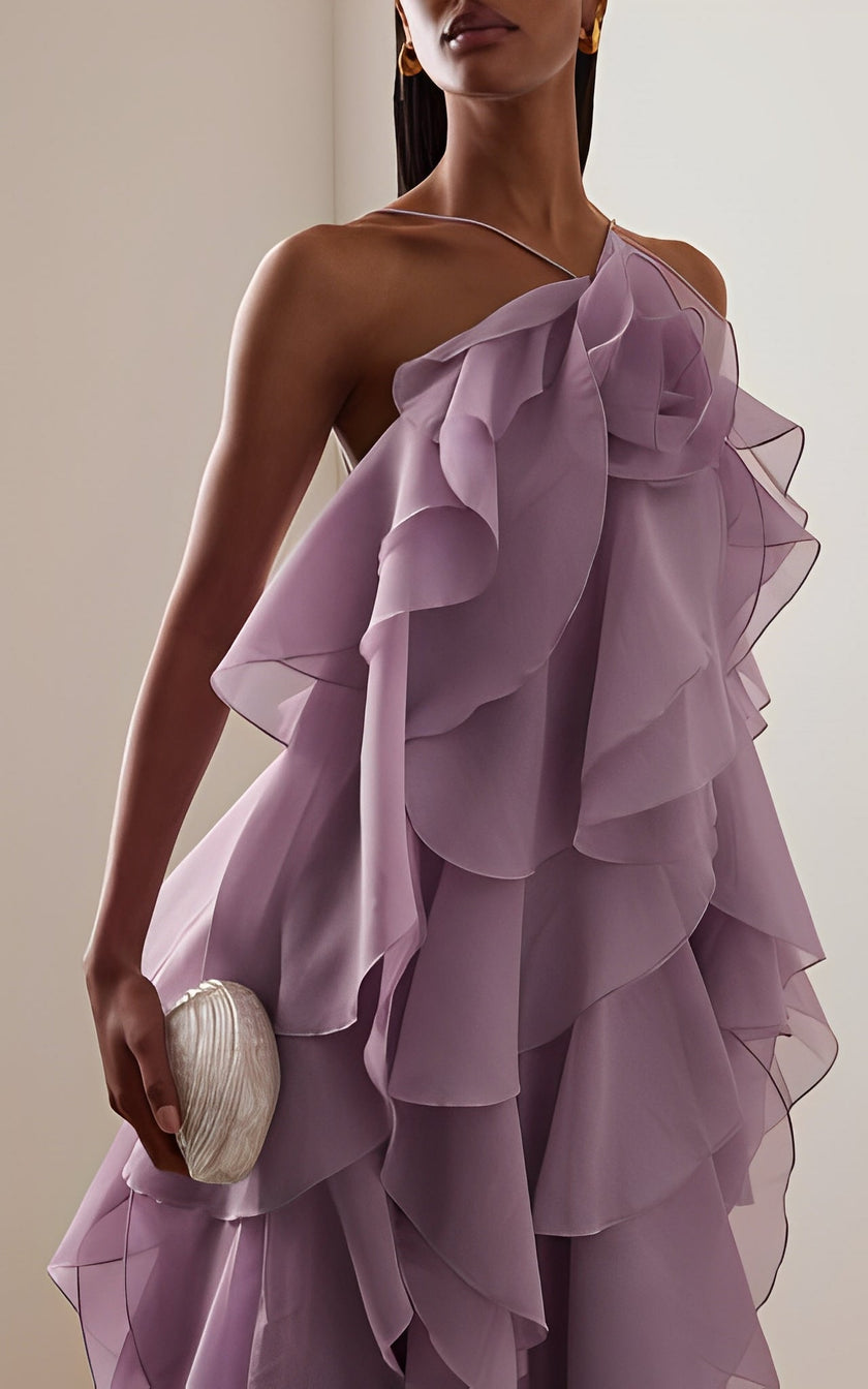 FJØRNA Pandorea layered maxi dress in flowing fabric with tiered design, displayed on a hanger against a neutral background.
