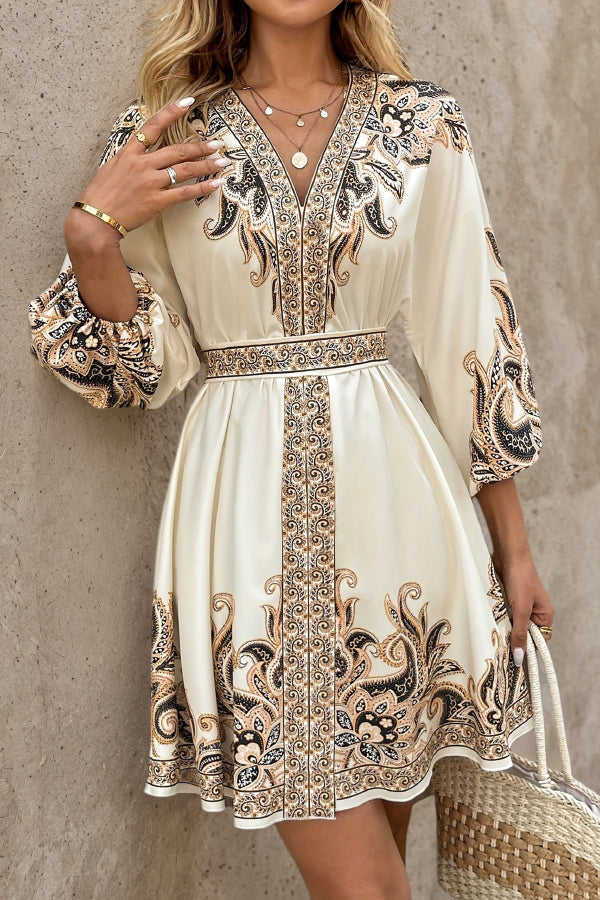 FJØRNA champagne mini dress with printed V-neck, lantern sleeves, and waist tie, perfect for stylish occasions.