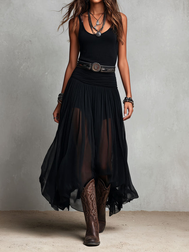 Black FJØRNA maxi dress with a casual, flowing silhouette, featuring a sleeveless design and a V-neck neckline.