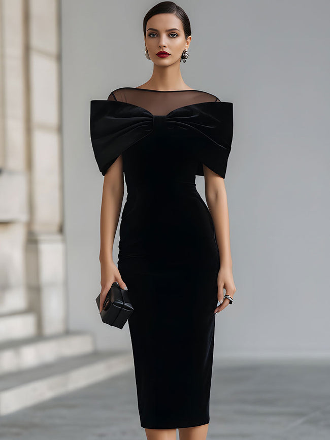 FJØRNA black velvet bow midi dress, elegant black tie dress with a fitted silhouette and bow detail at the waist.