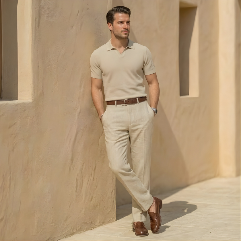 FJØRNA men's linen blend straight leg trousers with pleats and relaxed fit, shown in a neutral color on a model.