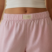 FJØRNA women's lounge trousers with elastic waist and pockets, featuring a relaxed fit and soft fabric for comfortable wear.