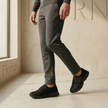 FJØRNA men's mesh trainers with lightweight breathable slip-on design, featuring a sleek black and gray athletic shoe style.