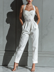 Ivory cotton-linen jumpsuit for women with V-neck, cinched waist, and wide-leg pants by FJØRNA, shown on a model.