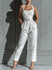 Ivory cotton-linen jumpsuit for women with V-neck, cinched waist, and wide-leg pants by FJØRNA, shown on a model.