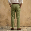 Men's linen blend straight leg trousers by FJØRNA with pleats, showcasing a relaxed fit and classic style.